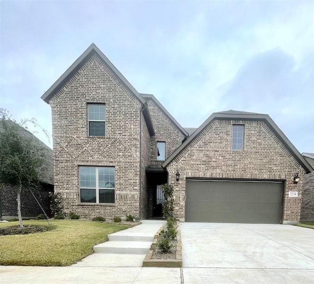 view of front property featuring a garage and a front yard