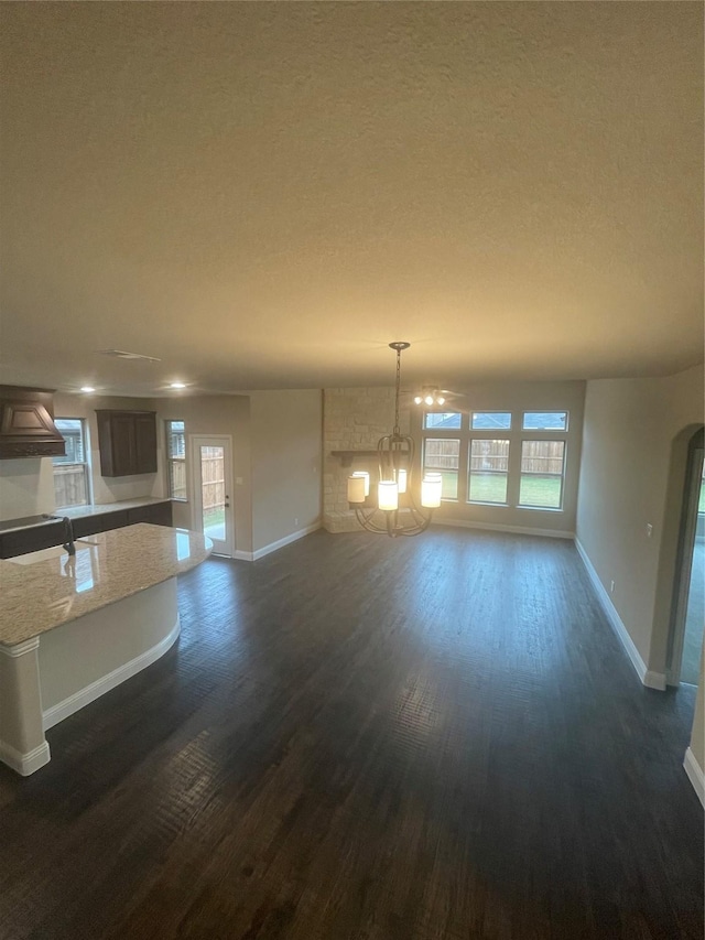 interior space featuring dark hardwood / wood-style floors, a textured ceiling, and an inviting chandelier