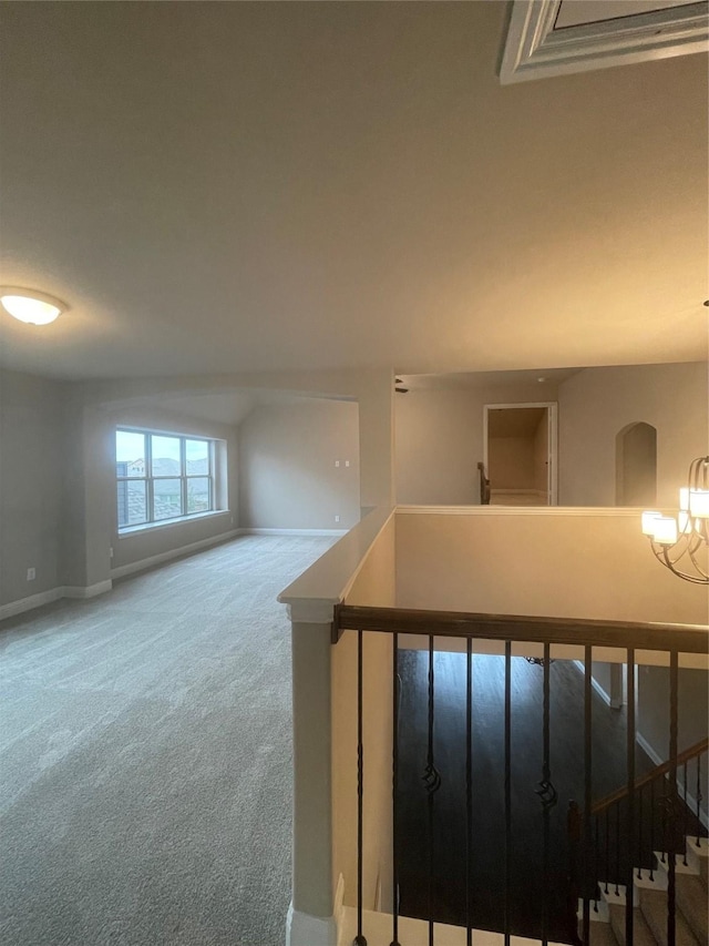 staircase featuring carpet and an inviting chandelier