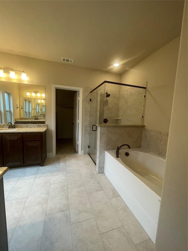 bathroom featuring vanity and shower with separate bathtub