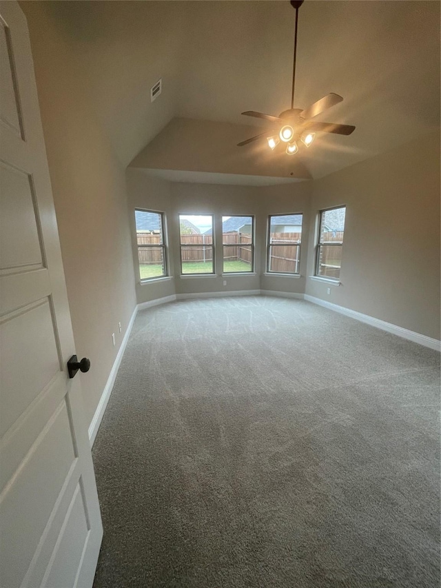 empty room with plenty of natural light, carpet flooring, and ceiling fan