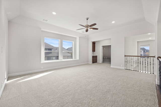 carpeted spare room featuring ceiling fan