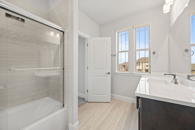 bathroom with vanity and combined bath / shower with glass door