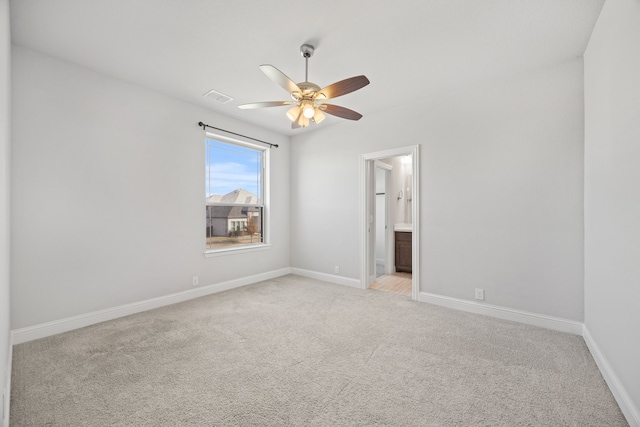 carpeted spare room with ceiling fan