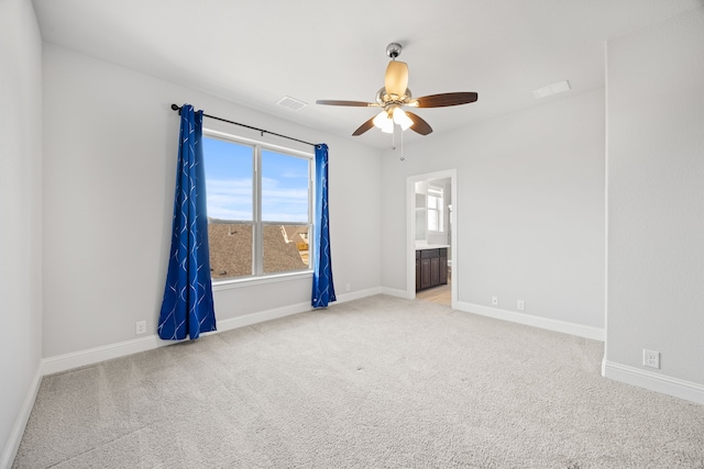 empty room featuring light carpet and ceiling fan