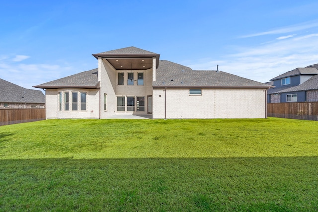 rear view of house with a yard