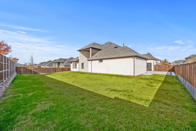 rear view of house with a lawn