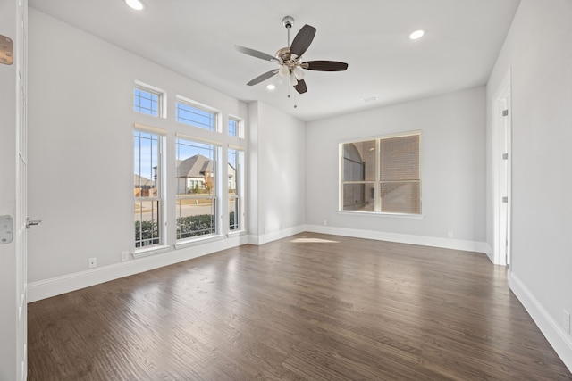 spare room with ceiling fan and dark hardwood / wood-style floors