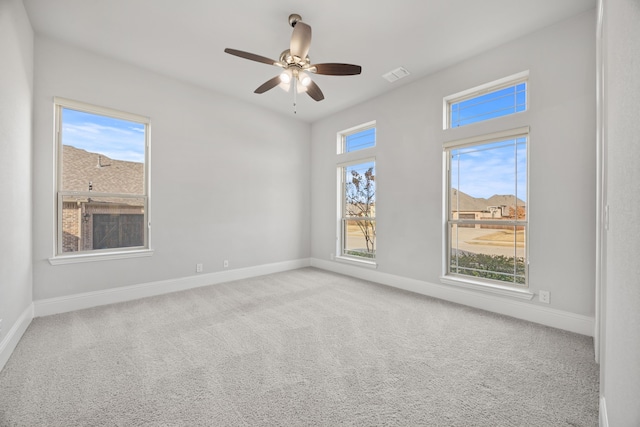 spare room with light colored carpet and ceiling fan