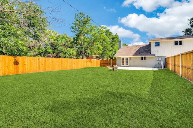 view of yard featuring french doors and a patio