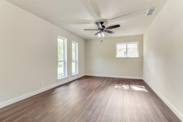 spare room with dark hardwood / wood-style floors and ceiling fan