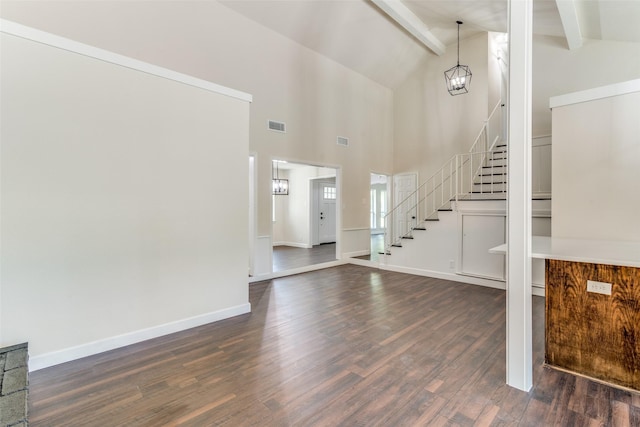 foyer with beam ceiling, dark hardwood / wood-style flooring, and high vaulted ceiling