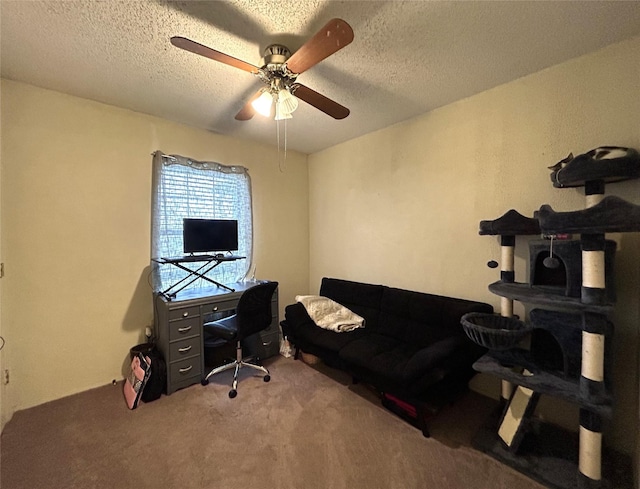 office area featuring ceiling fan, carpet floors, and a textured ceiling