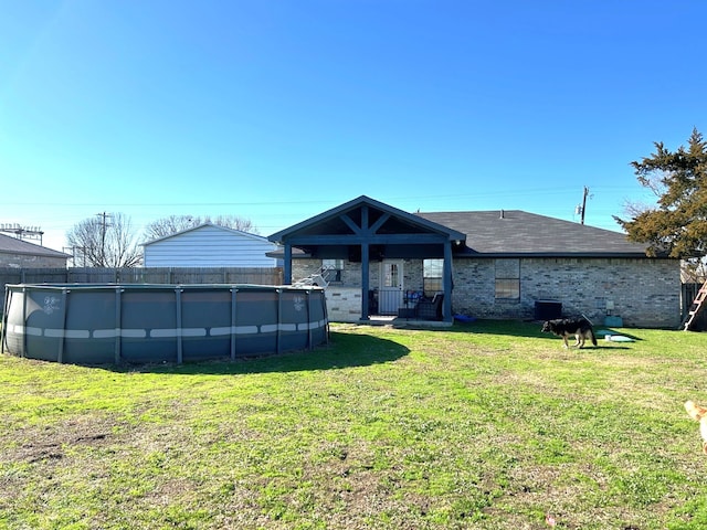 back of property featuring a lawn