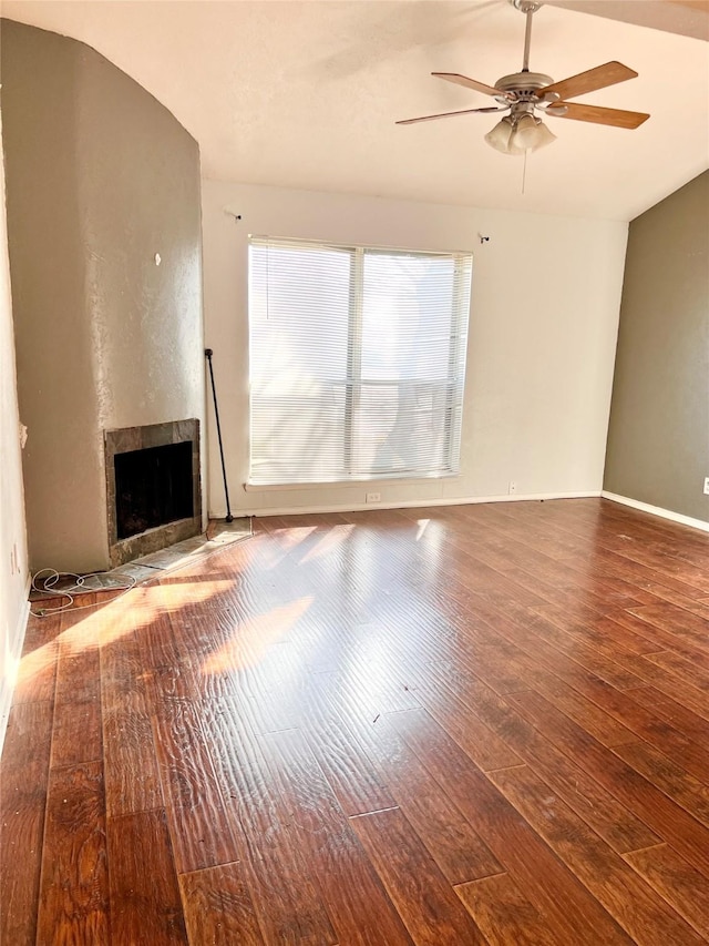 unfurnished living room featuring ceiling fan and hardwood / wood-style floors