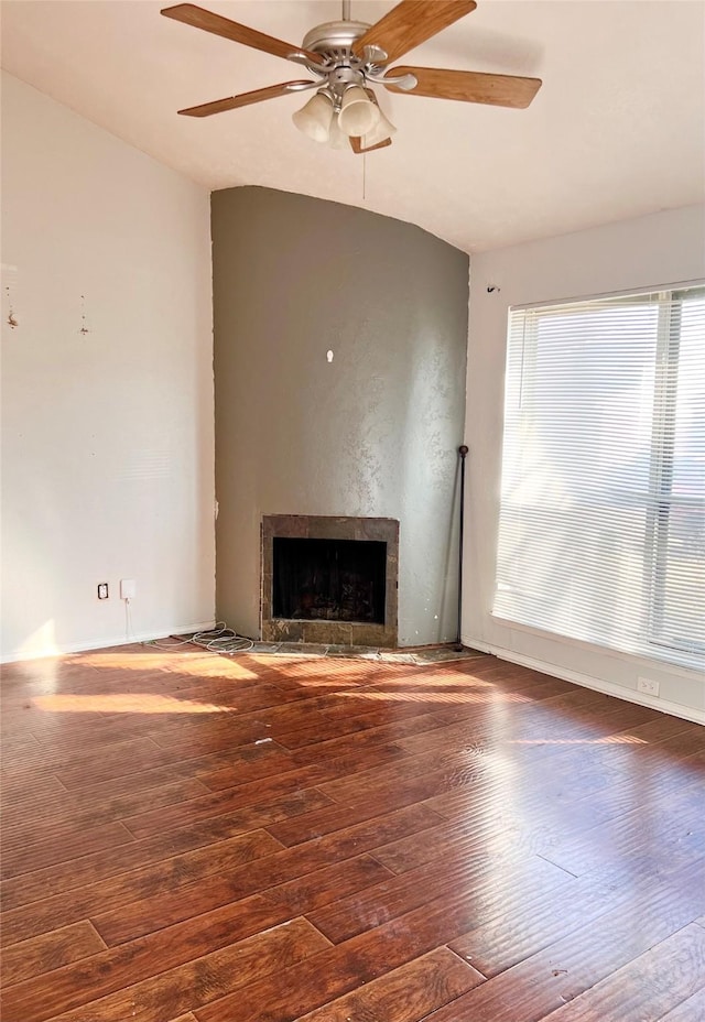 unfurnished living room with ceiling fan and dark hardwood / wood-style flooring