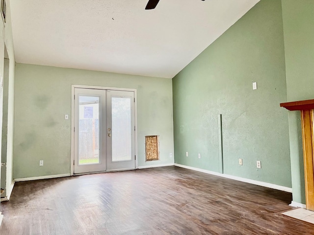 spare room with ceiling fan, vaulted ceiling, wood-type flooring, and french doors