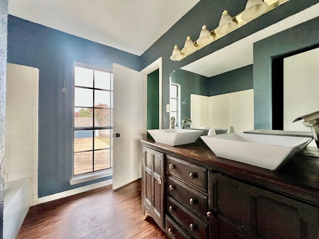 bathroom with bathing tub / shower combination, hardwood / wood-style floors, and vanity