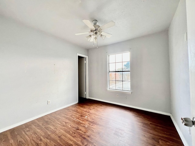 spare room featuring a textured ceiling, ceiling fan, and dark hardwood / wood-style floors