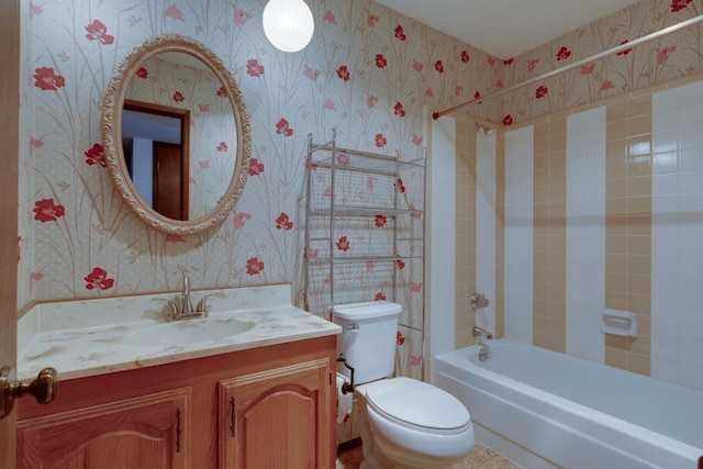 full bathroom with vanity, tiled shower / bath combo, and toilet