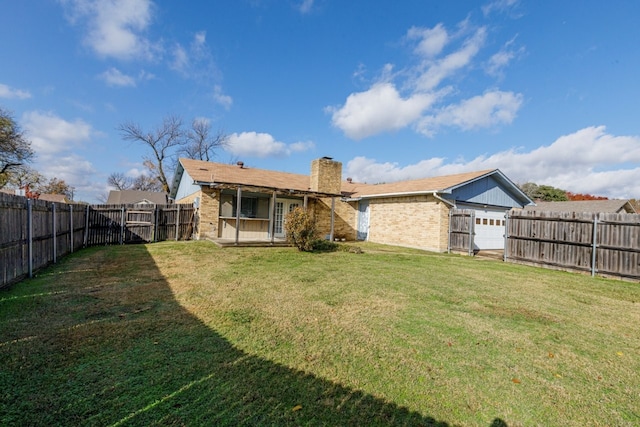 rear view of house featuring a yard