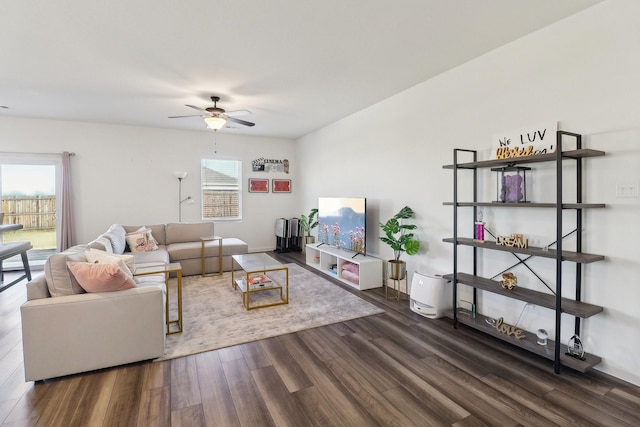 living room featuring ceiling fan and dark wood-type flooring