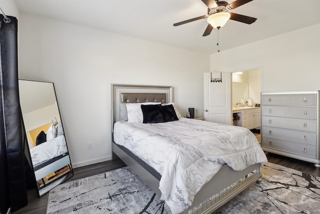 bedroom featuring ceiling fan, dark hardwood / wood-style floors, and connected bathroom