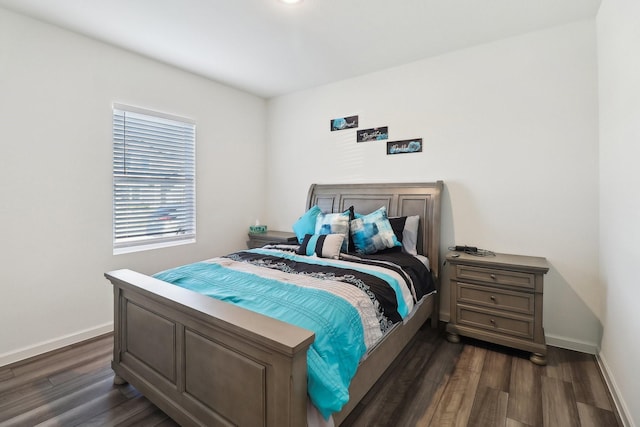 bedroom with dark hardwood / wood-style flooring