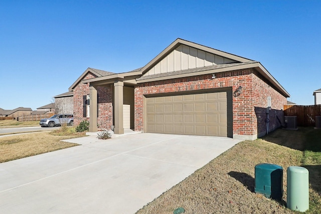 ranch-style home featuring a garage and cooling unit