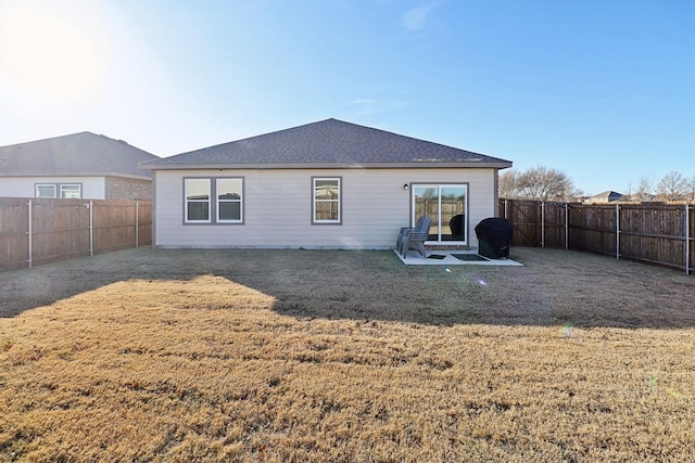 rear view of house featuring a yard