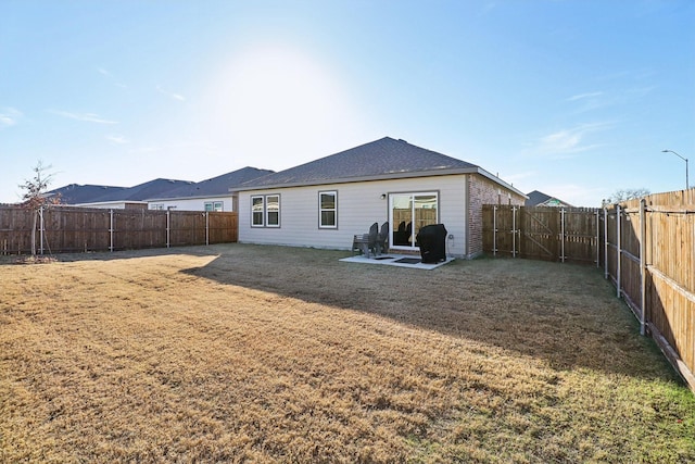 rear view of property featuring a lawn