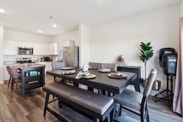 dining space with dark hardwood / wood-style floors