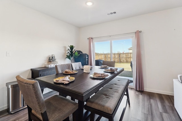 dining area with dark wood-type flooring