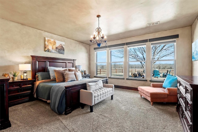 carpeted bedroom with an inviting chandelier