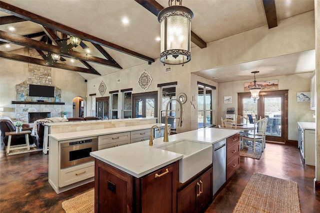 12201 Madison Ln, Justin, TX 76247 - kitchen featuring a sink, beamed ceiling, a kitchen island with sink, high vaulted ceiling, and light countertops