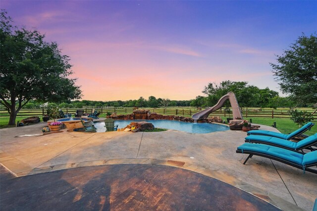 12201 Madison Ln, Justin, TX 76247 - pool at dusk featuring a water slide and a patio
