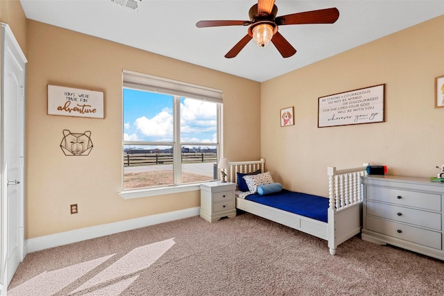 bedroom featuring light colored carpet and ceiling fan