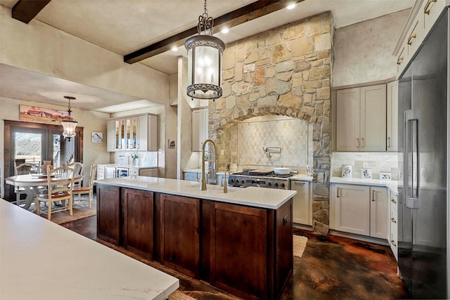 12201 Madison Ln, Justin, TX 76247 - kitchen featuring high end fridge, beam ceiling, light countertops, decorative backsplash, and a center island with sink
