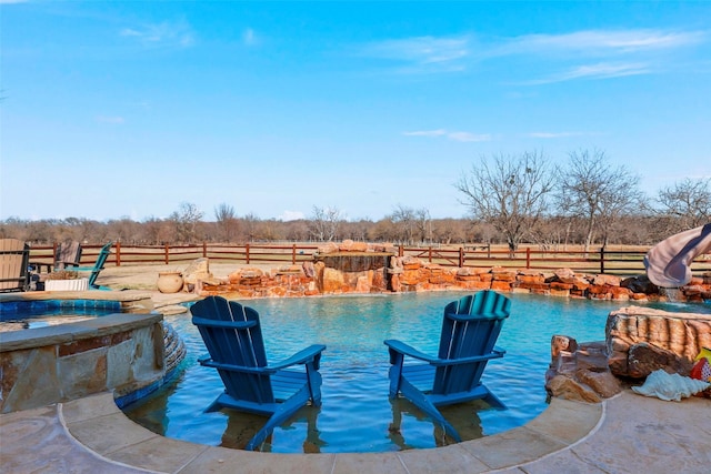 view of swimming pool featuring a rural view and pool water feature