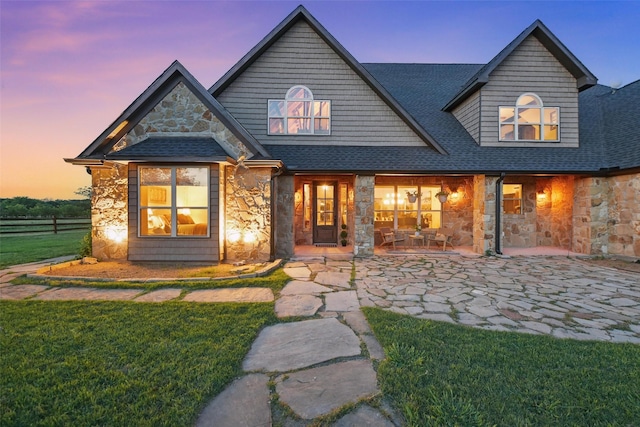 12201 Madison Ln, Justin, TX 76247 - back of house with stone siding, a shingled roof, and a patio