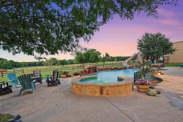 12201 Madison Ln, Justin, TX 76247 - view of pool featuring a water slide, an in-ground hot tub, and a patio area