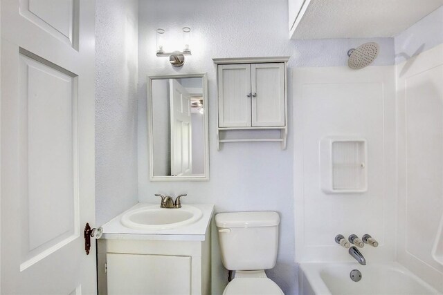 unfurnished bedroom with ceiling fan, dark wood-type flooring, and ensuite bathroom