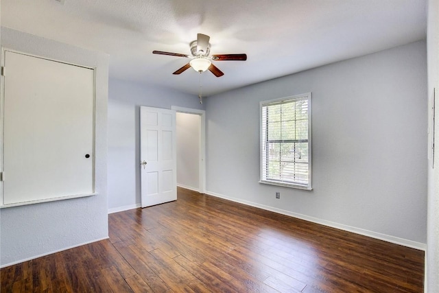 708 N US Highway 69, Celeste, TX 75423 - unfurnished bedroom with wood finished floors, a ceiling fan, and baseboards