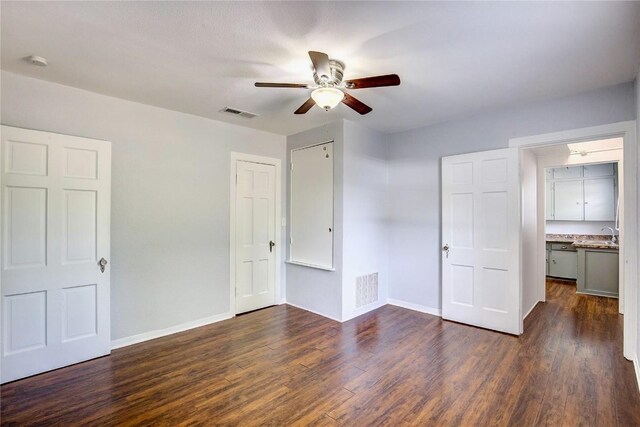 unfurnished room featuring dark hardwood / wood-style floors and ceiling fan