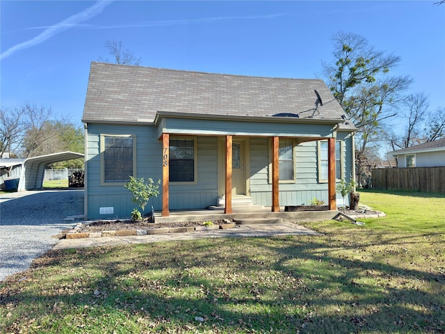 bungalow with a front lawn, a porch, and a carport