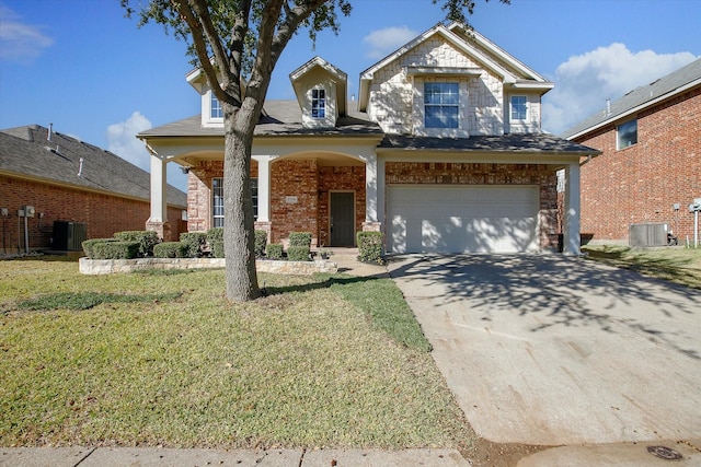 craftsman house with central AC unit, a garage, and a front yard