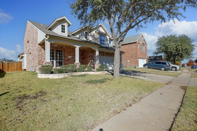 view of front of property featuring covered porch, a front yard, and a garage