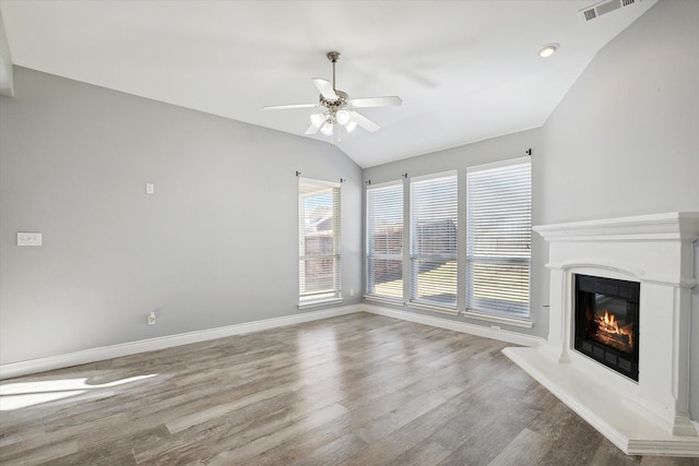 unfurnished living room featuring vaulted ceiling, wood-type flooring, and ceiling fan