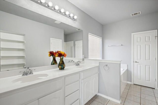 bathroom featuring vanity, a bath, and tile patterned flooring