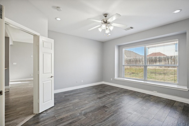 unfurnished room featuring ceiling fan and dark hardwood / wood-style floors